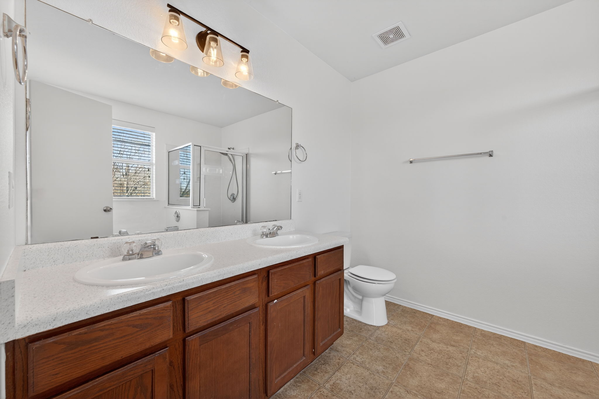 13629 Coomer Path Pflugerville, TX 78660 - Photo 14 of 30 Full bath featuring double vanity and a shower stall