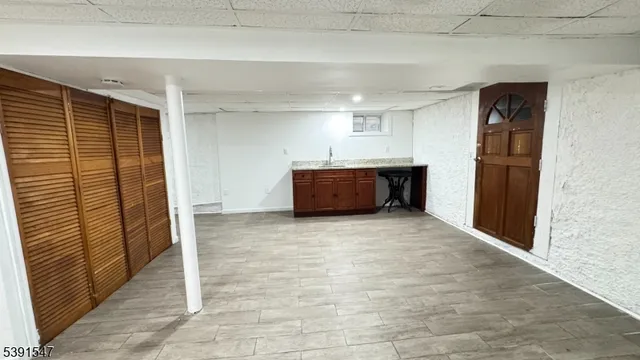 a view of kitchen with refrigerator and window