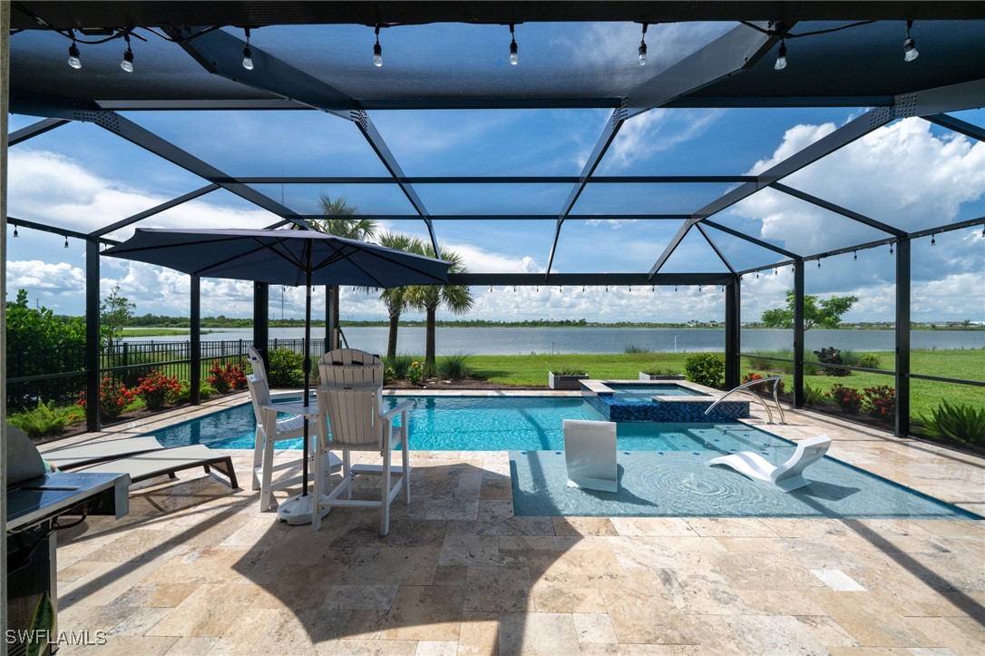 a view of a patio with a table and chairs under an umbrella