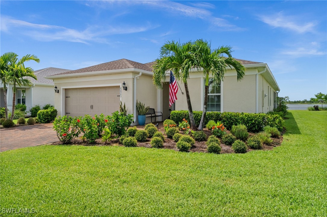 42243 Edgewater Drive Punta Gorda, FL 33982 - Photo 16 of 46 a front view of a house with a garden