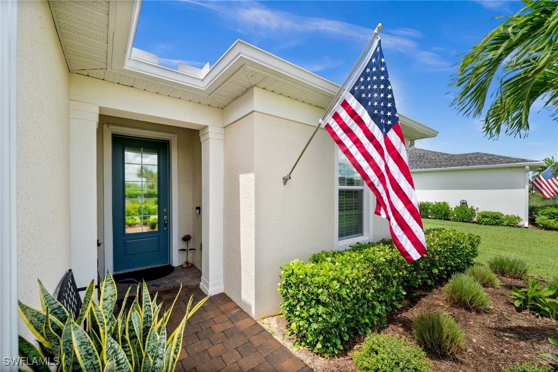 42243 Edgewater Drive Punta Gorda, FL 33982 - Photo 17 of 46 a front view of a house with entryway and flower