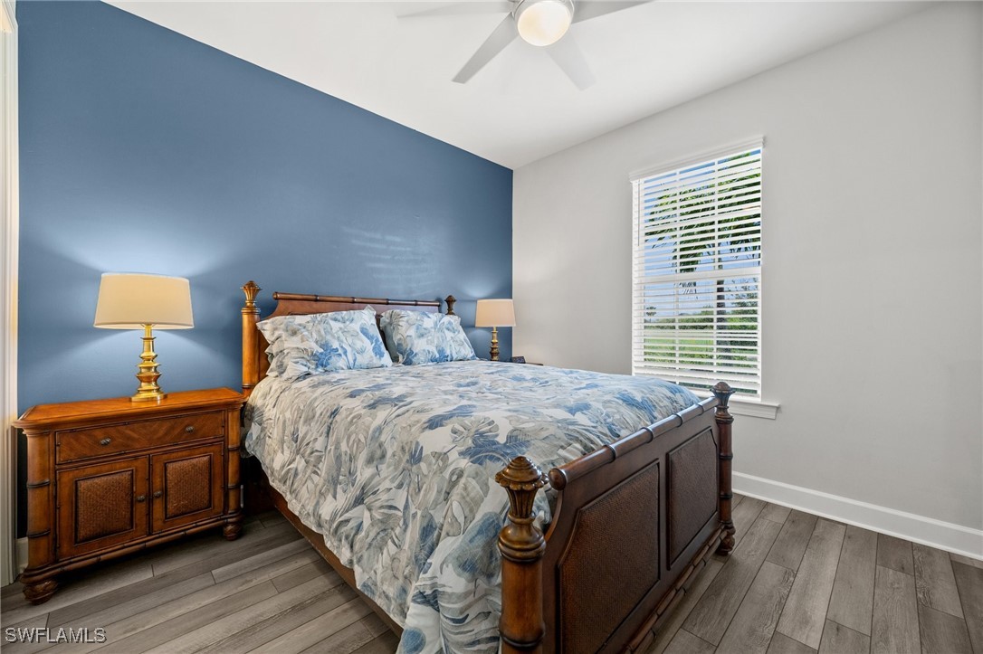 42243 Edgewater Drive Punta Gorda, FL 33982 - Photo 18 of 46 a bedroom with a bed and wooden floor