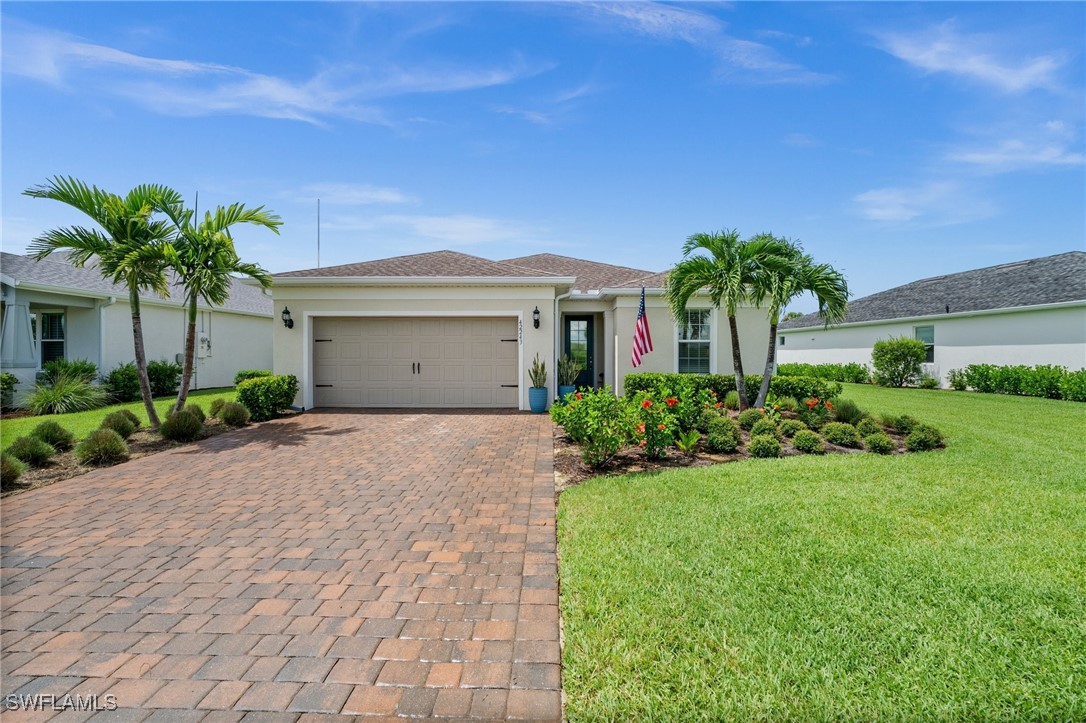 42243 Edgewater Drive Punta Gorda, FL 33982 - Photo 2 of 46 a front view of a house with a garden