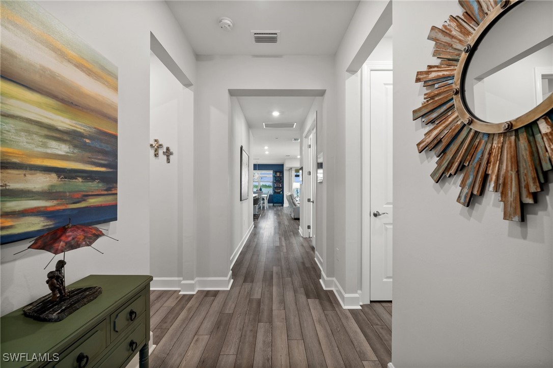 42243 Edgewater Drive Punta Gorda, FL 33982 - Photo 24 of 46 a view of a hallway with wooden floor and furniture