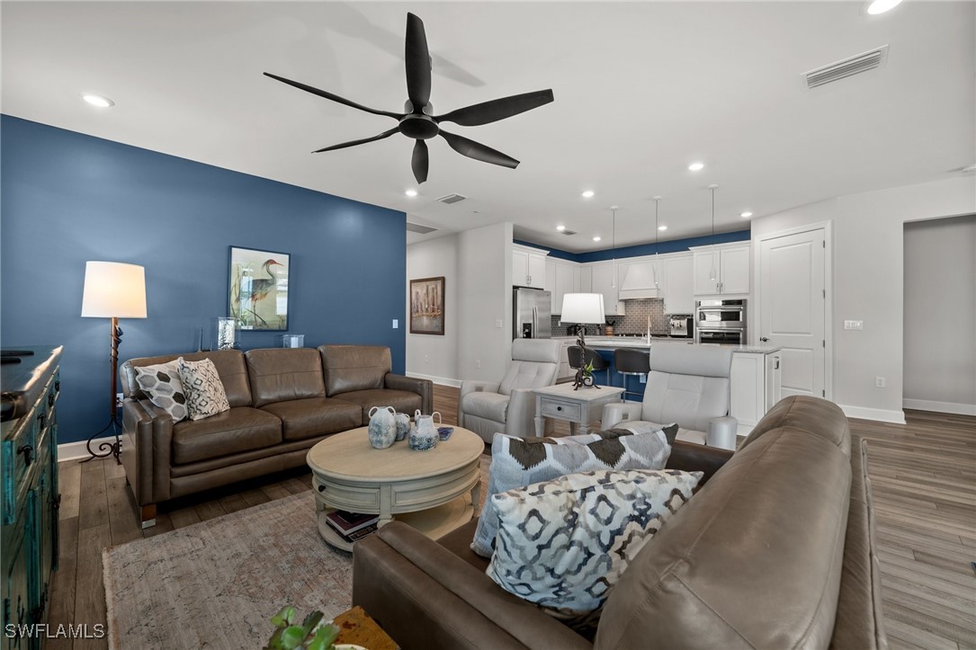 42243 Edgewater Drive Punta Gorda, FL 33982 - Photo 33 of 46 a living room with furniture kitchen view and a chandelier