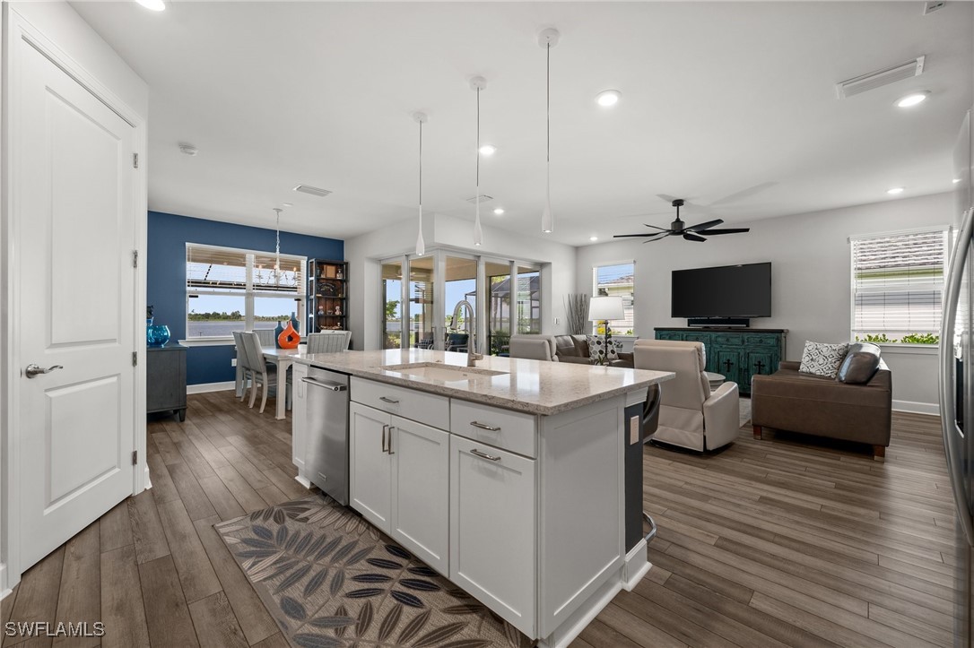 42243 Edgewater Drive Punta Gorda, FL 33982 - Photo 37 of 46 a large kitchen with stainless steel appliances kitchen island granite countertop a large island in the center