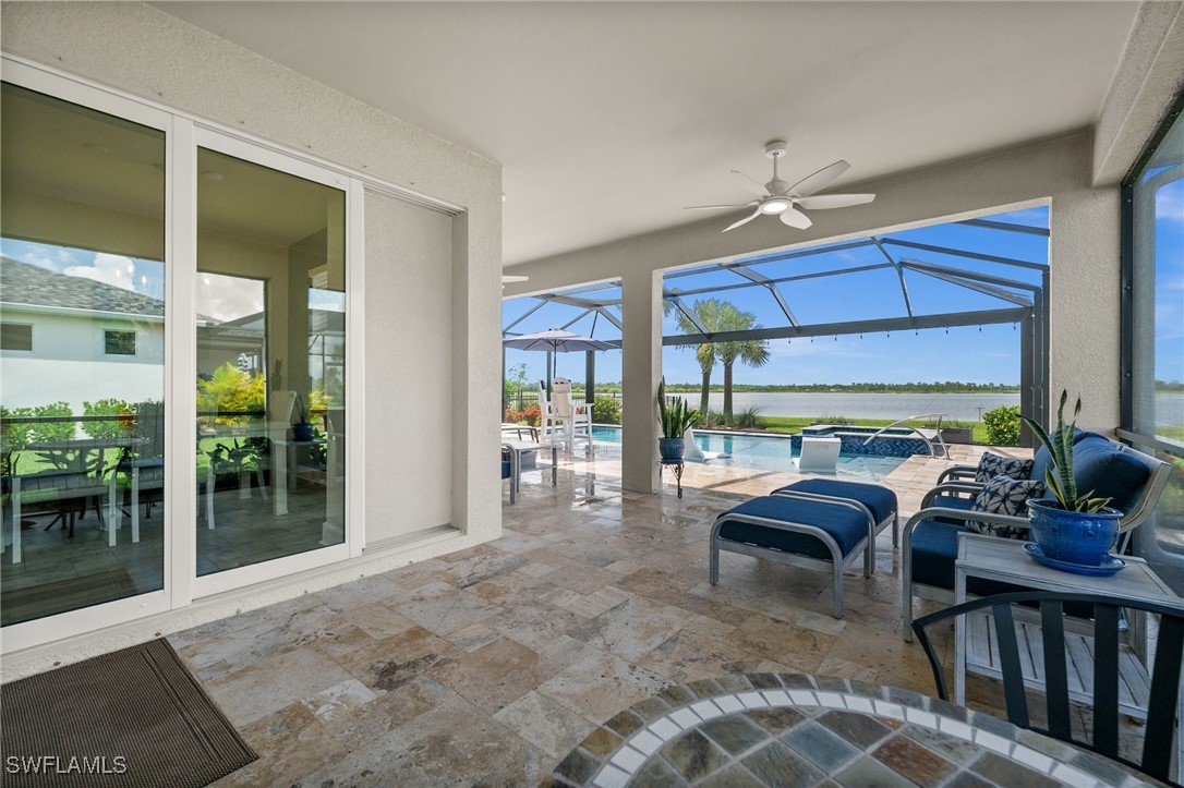 42243 Edgewater Drive Punta Gorda, FL 33982 - Photo 7 of 46 a living room with furniture a floor to ceiling window and wooden floor