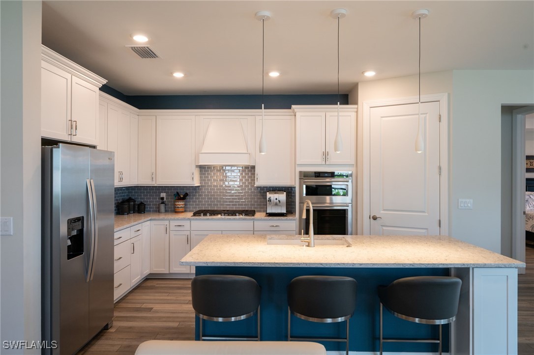 42243 Edgewater Drive Punta Gorda, FL 33982 - Photo 8 of 46 a kitchen with kitchen island a sink stainless steel appliances and cabinets
