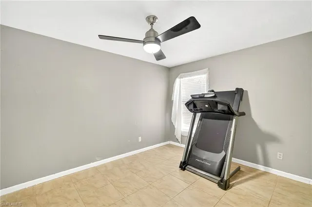 a room with gym equipment and windows