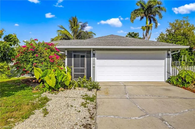 a view of a house with a flower garden