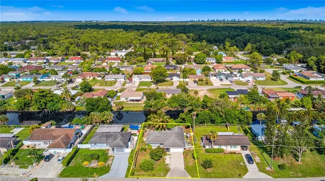 an aerial view of a houses with yard