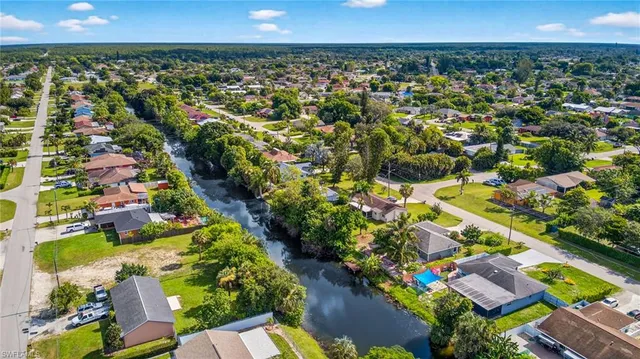 an aerial view of a houses with a yard