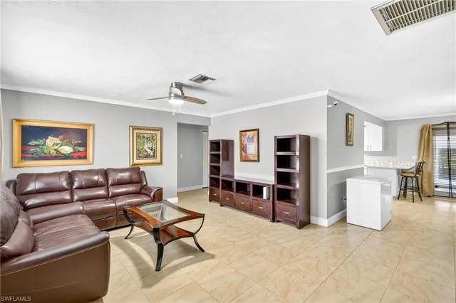 a living room with furniture a dining table and a piano with wooden floor