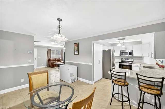 a dining room with furniture a chandelier and wooden floor