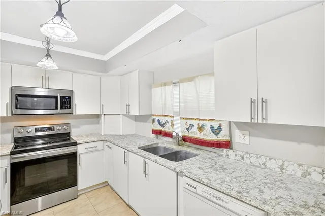 a kitchen with stainless steel appliances granite countertop a sink and a stove