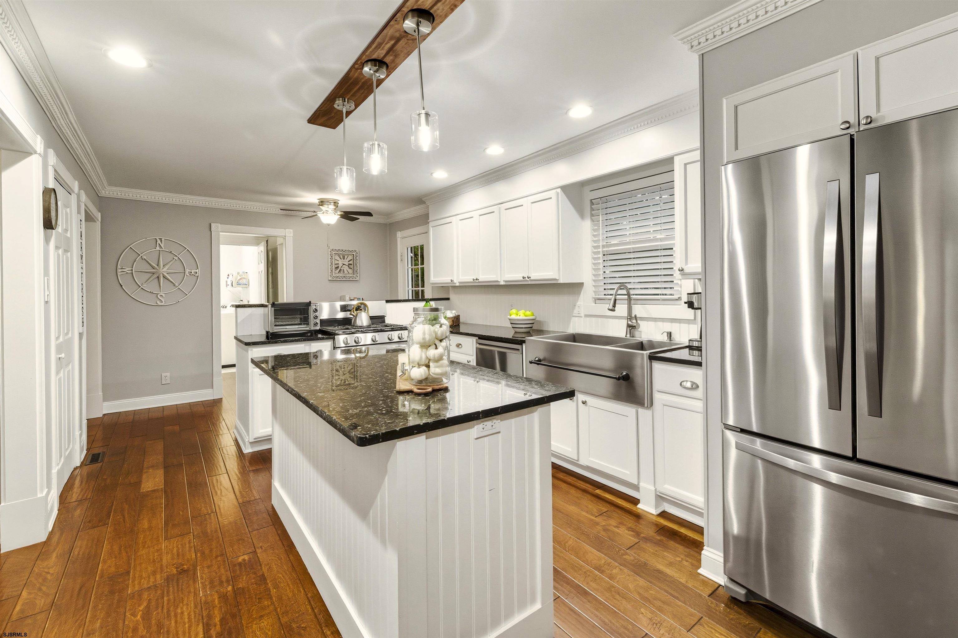 1100 Spring Lane Absecon, NJ 08201 - Photo 11 of 25 a kitchen with kitchen island a sink appliances and cabinets