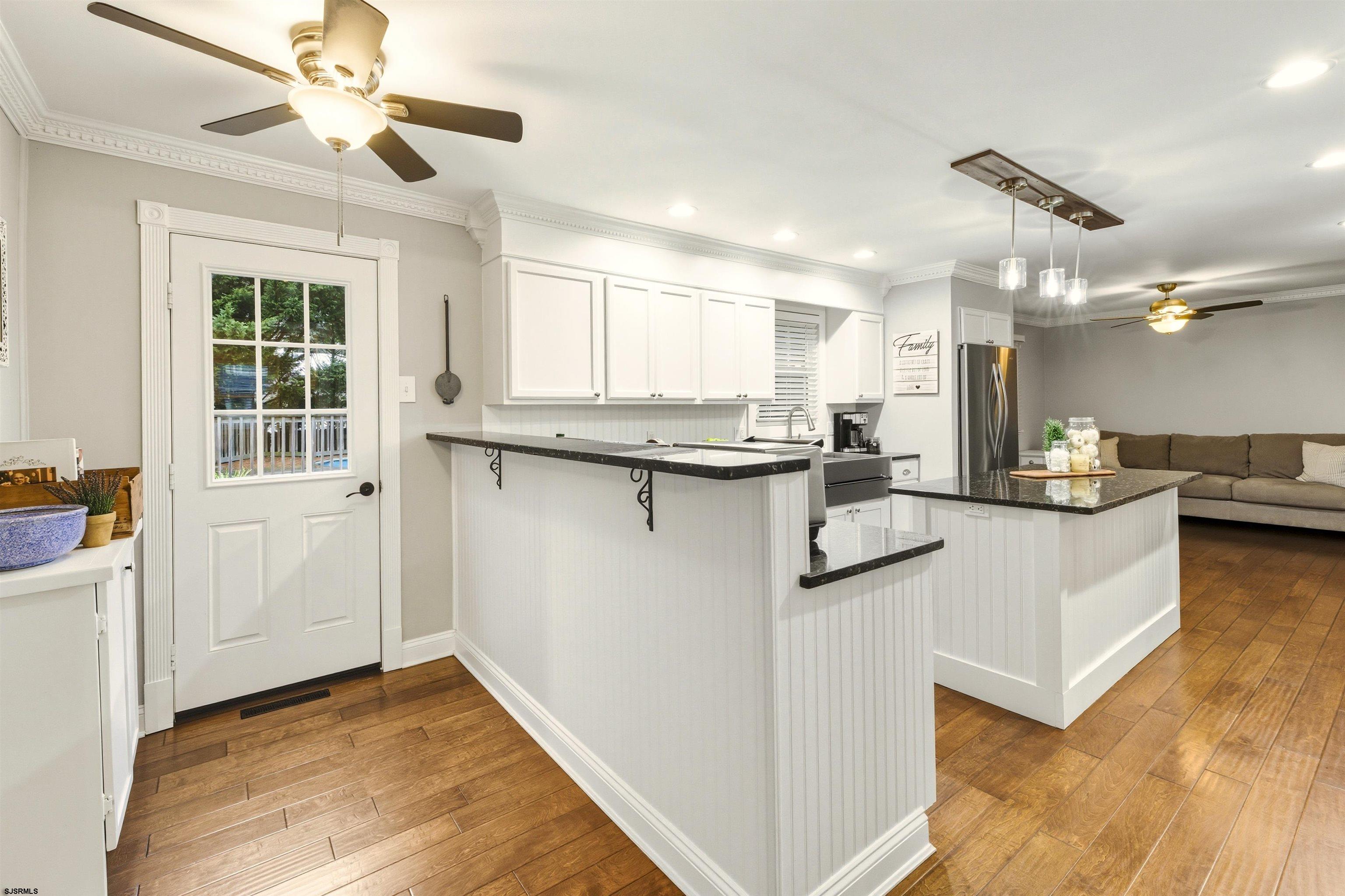 1100 Spring Lane Absecon, NJ 08201 - Photo 12 of 25 a kitchen with kitchen island a stove a sink and a refrigerator