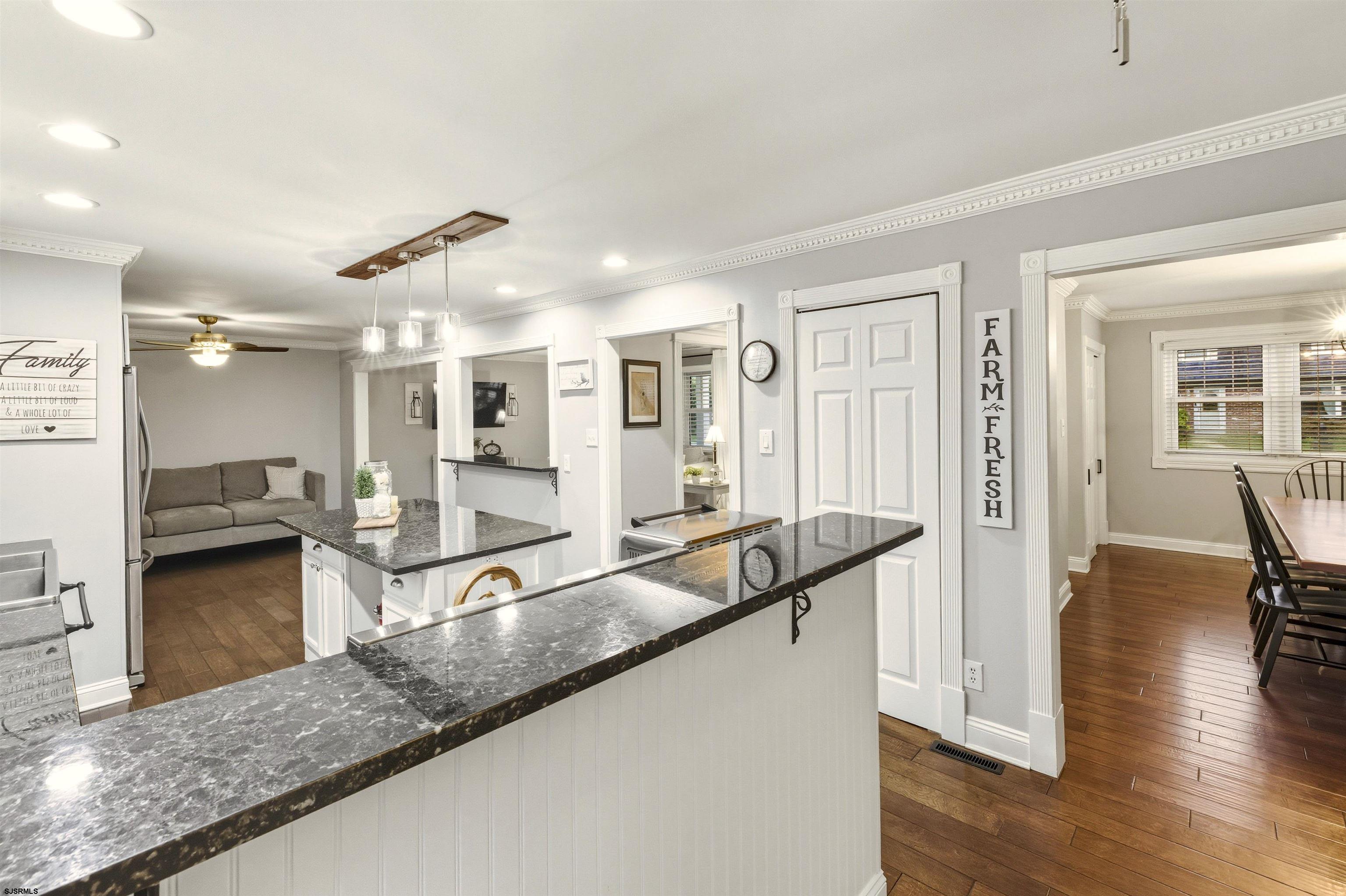 1100 Spring Lane Absecon, NJ 08201 - Photo 13 of 25 a large living room with stainless steel appliances granite countertop furniture and a wooden floor