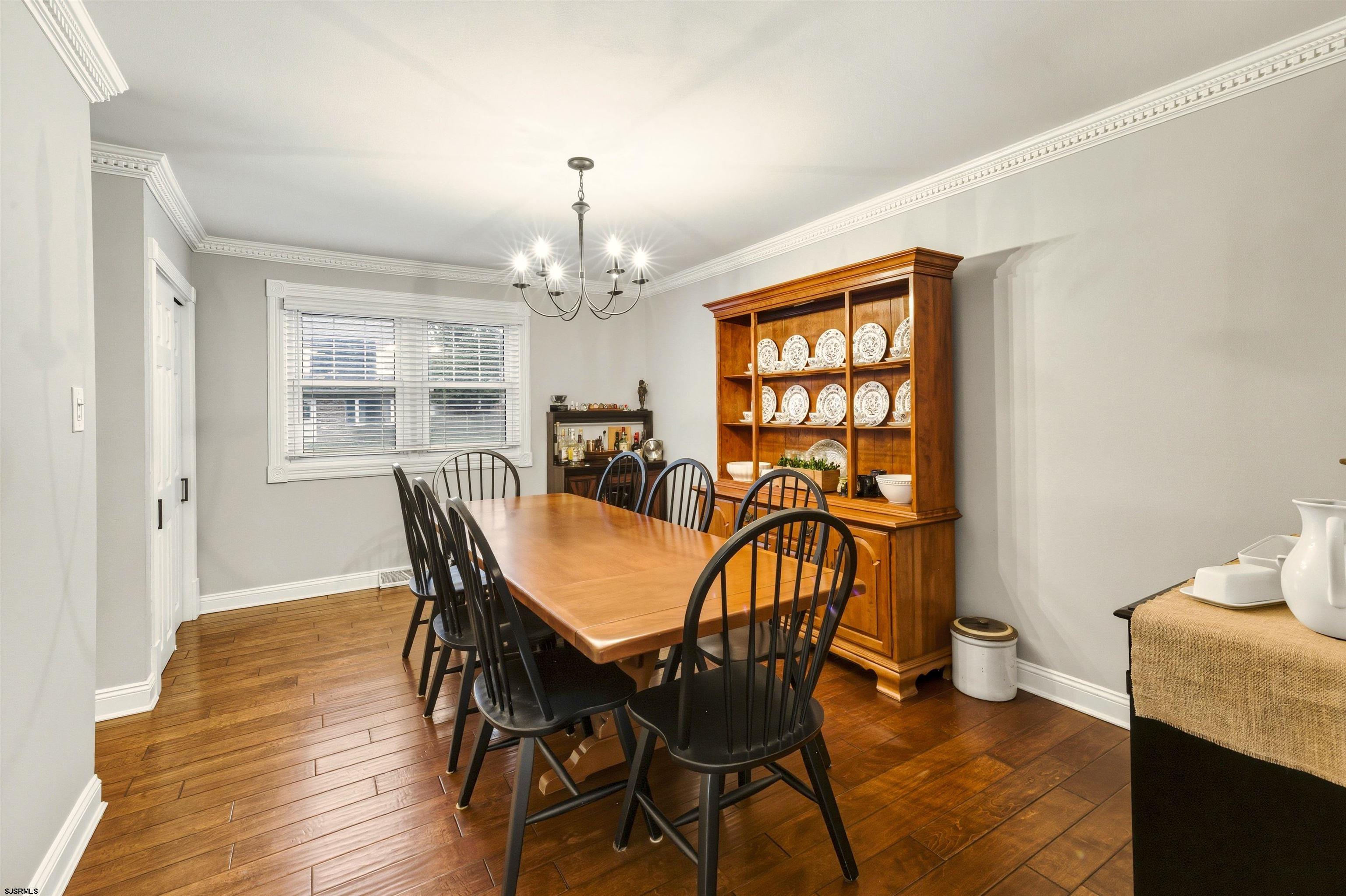 1100 Spring Lane Absecon, NJ 08201 - Photo 14 of 25 a view of a dining room with furniture and chandelier