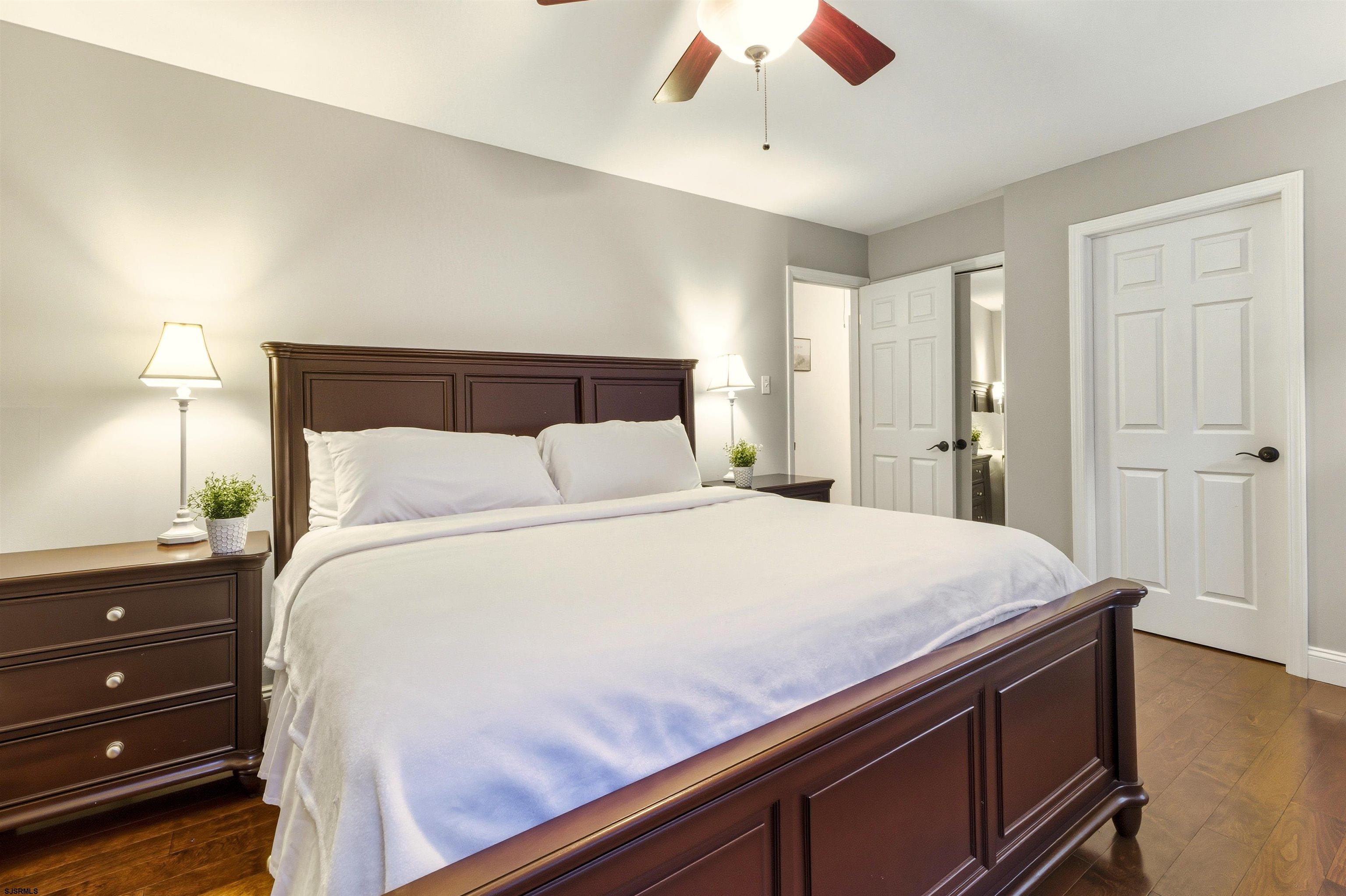 1100 Spring Lane Absecon, NJ 08201 - Photo 19 of 25 a bedroom with a bed and a chandelier