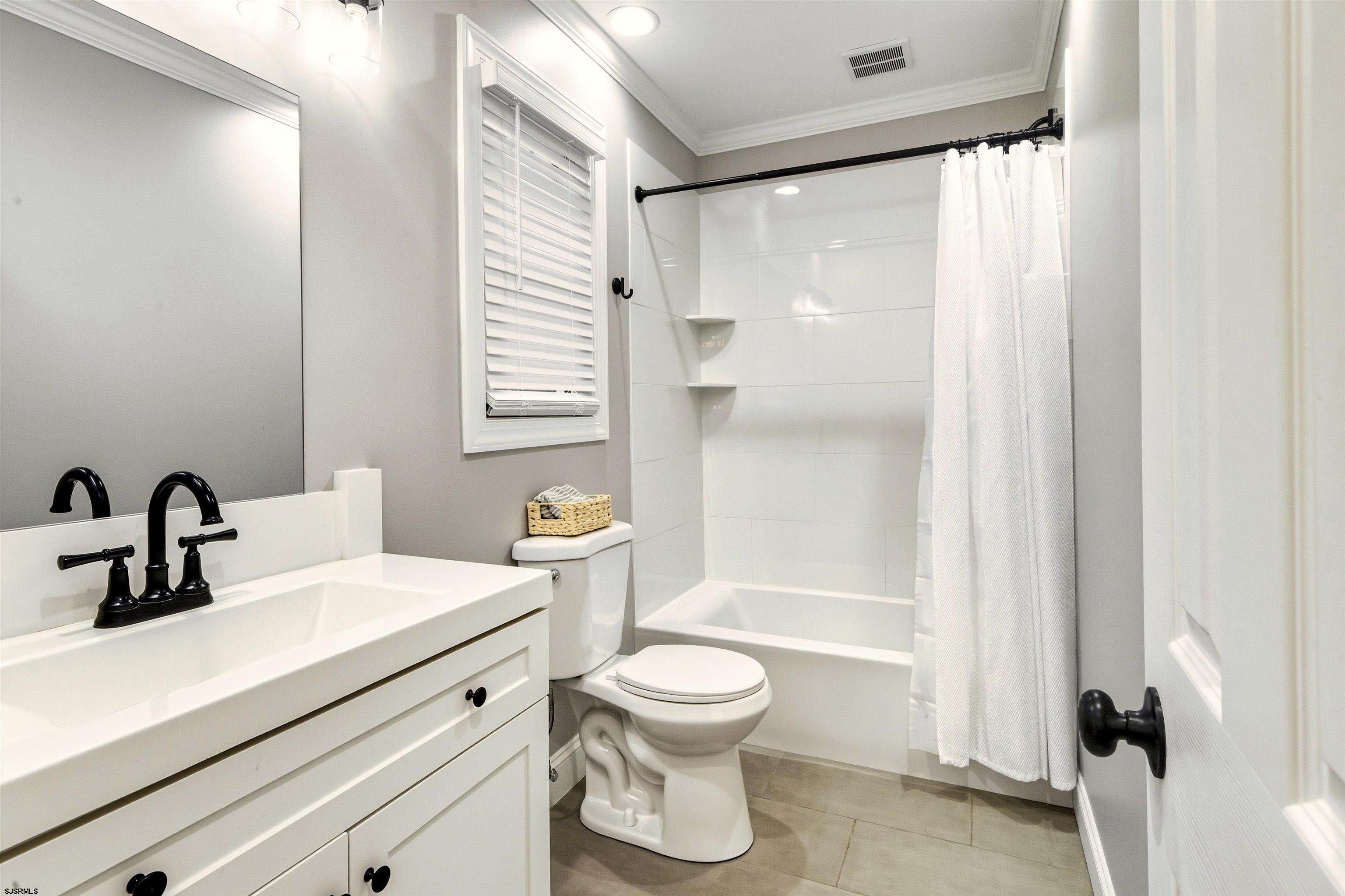 1100 Spring Lane Absecon, NJ 08201 - Photo 20 of 25 a bathroom with a sink a toilet and a shower