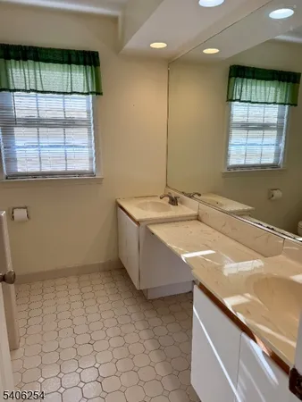 a bathroom with a sink a vanity and a bathtub