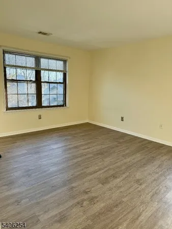 wooden floor and window in an empty room