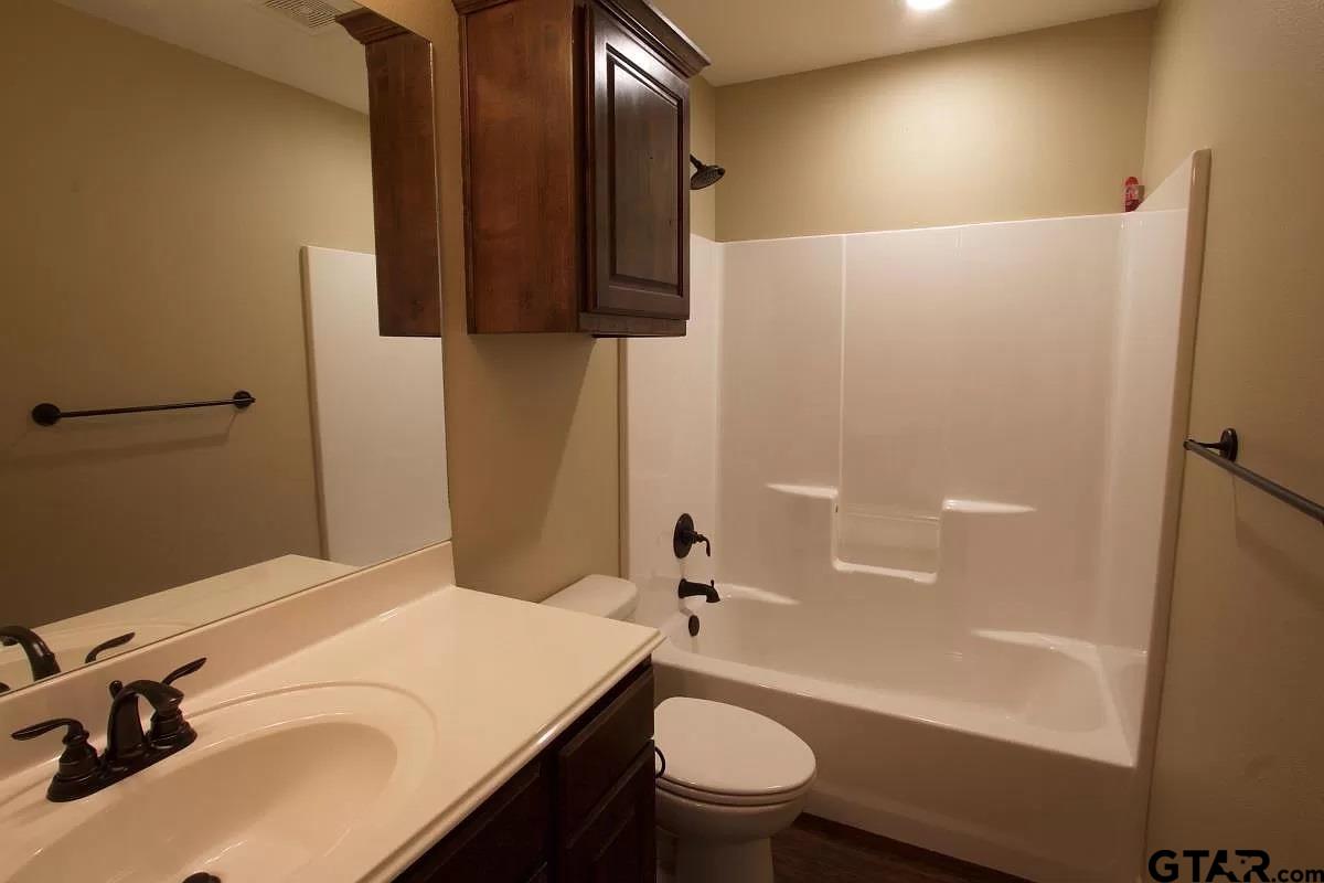 308 Princess Place Tyler, TX 75704 - Photo 3 of 9 a bathroom with a sink a toilet and shower
