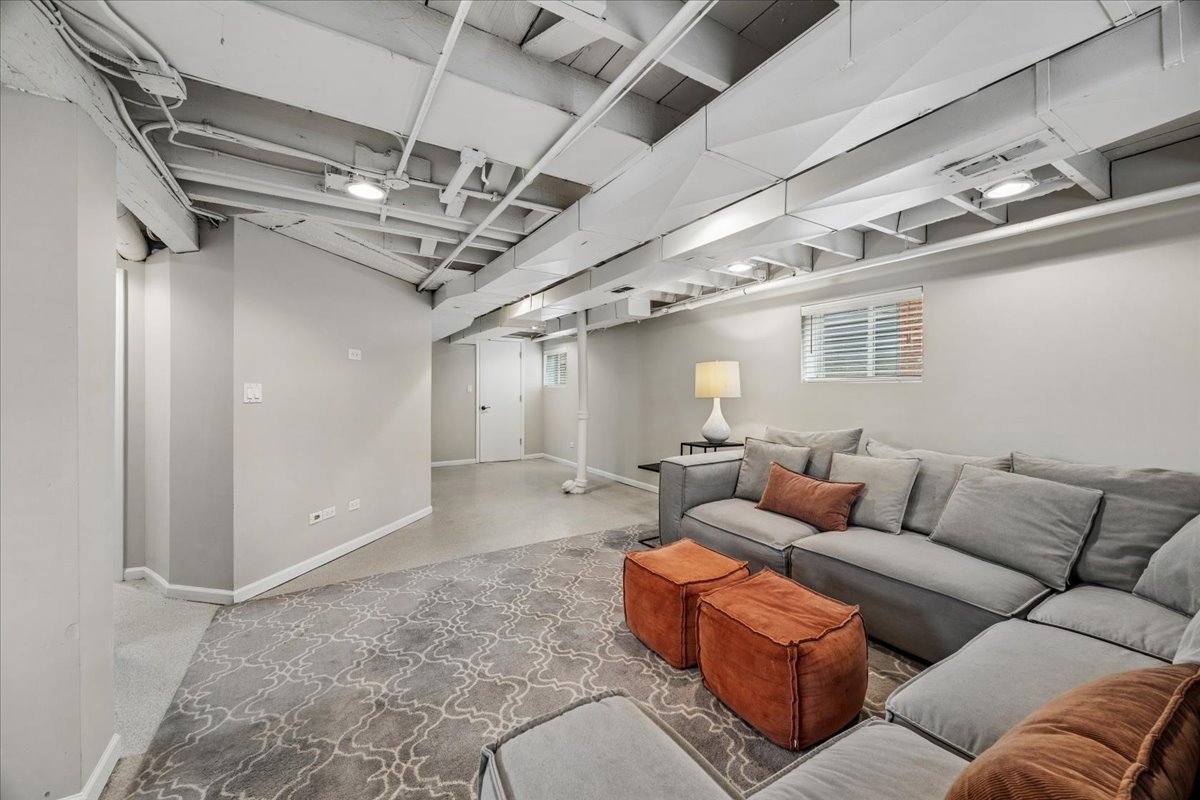 347 Keystone Avenue River Forest, IL 60305 - Photo 27 of 36 a living room with furniture a chandelier and a projector