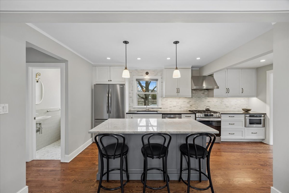 347 Keystone Avenue River Forest, IL 60305 - Photo 7 of 36 a kitchen with stainless steel appliances kitchen island granite countertop a stove a refrigerator a oven a sink with a dining table and chairs