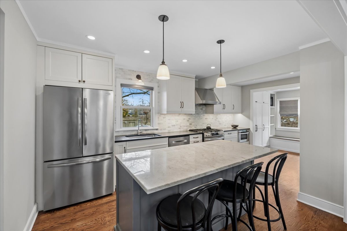 347 Keystone Avenue River Forest, IL 60305 - Photo 8 of 36 a kitchen with stainless steel appliances granite countertop a refrigerator a sink a stove a dining table and chairs