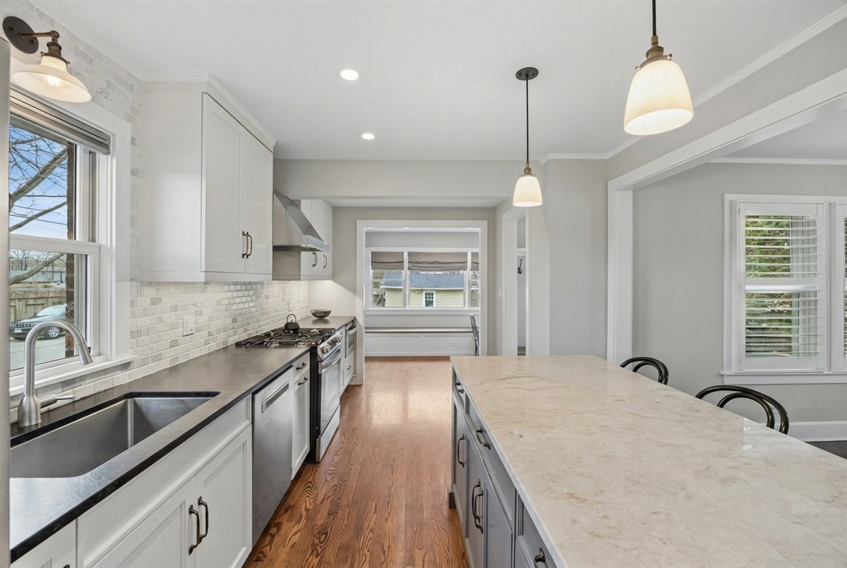 347 Keystone Avenue River Forest, IL 60305 - Photo 9 of 36 a large kitchen with kitchen island a large counter space a sink appliances and cabinets