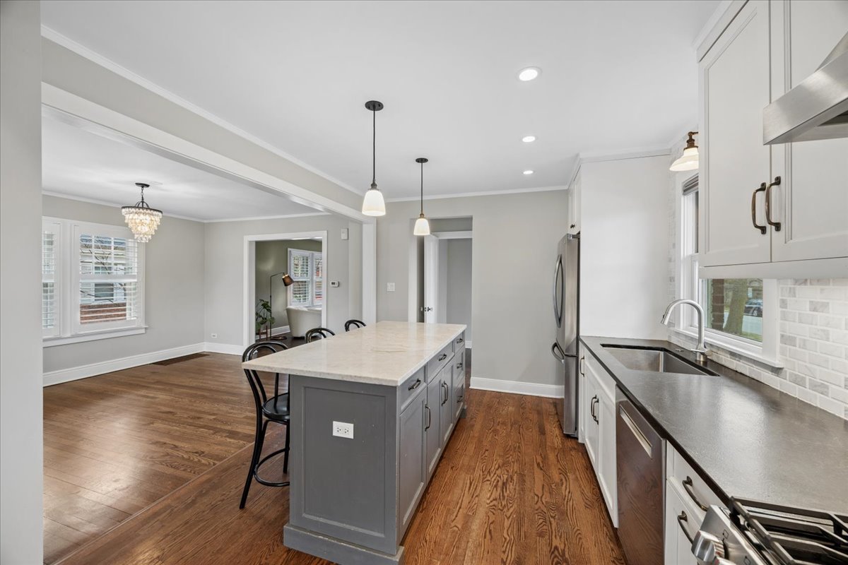 347 Keystone Avenue River Forest, IL 60305 - Photo 10 of 36 a large kitchen with kitchen island a sink stove a refrigerator and a stove with wooden floor