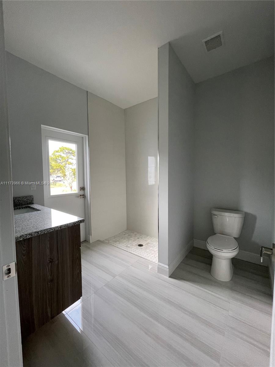 2072 Southwest Akorot Road Port St. Lucie, FL 34953 - Photo 11 of 14 a bathroom with a sink toilet and window