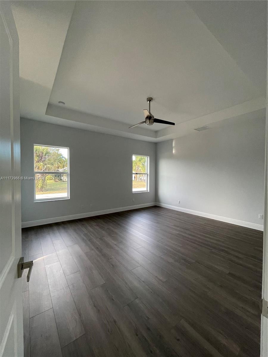 2072 Southwest Akorot Road Port St. Lucie, FL 34953 - Photo 12 of 14 an empty room with wooden floor and windows