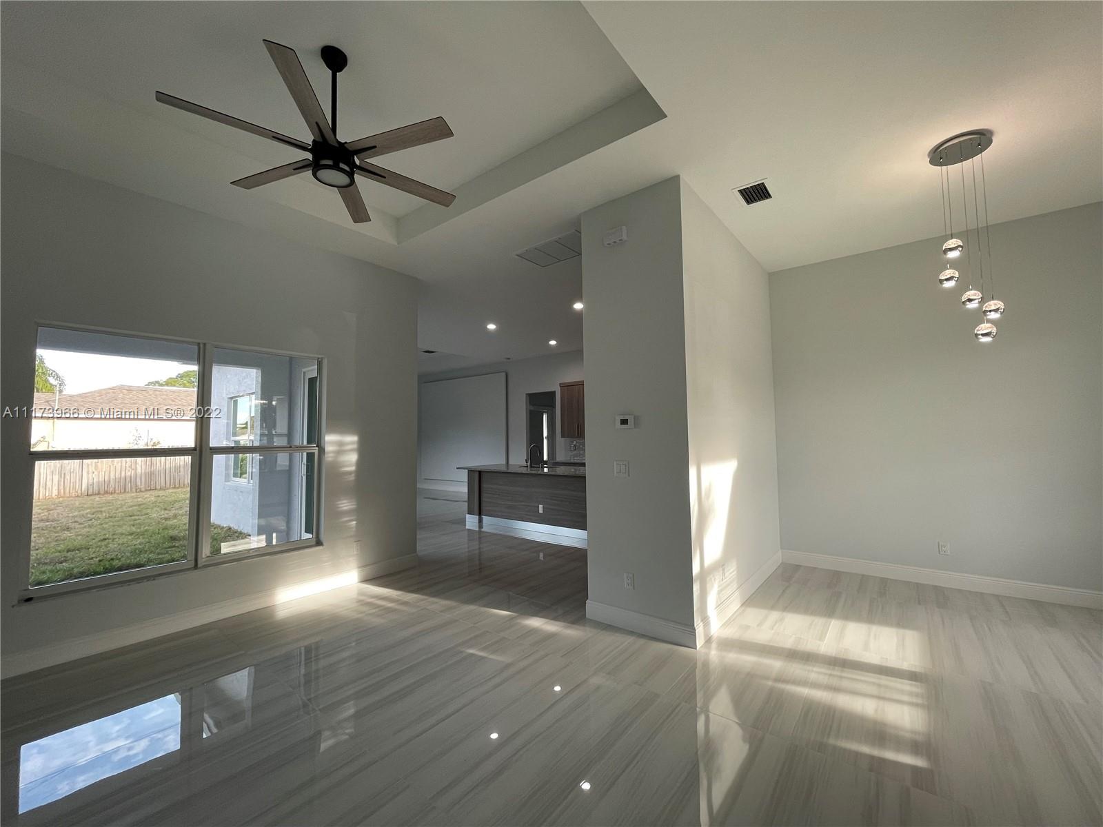 2072 Southwest Akorot Road Port St. Lucie, FL 34953 - Photo 2 of 14 a view of a livingroom with a ceiling fan and window
