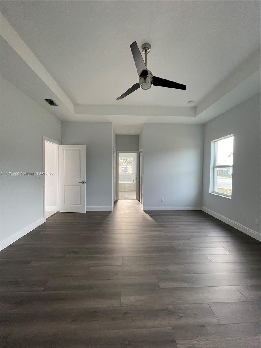 2072 Southwest Akorot Road Port St. Lucie, FL 34953 - Photo 5 of 14 a view of empty room with wooden floor and fan
