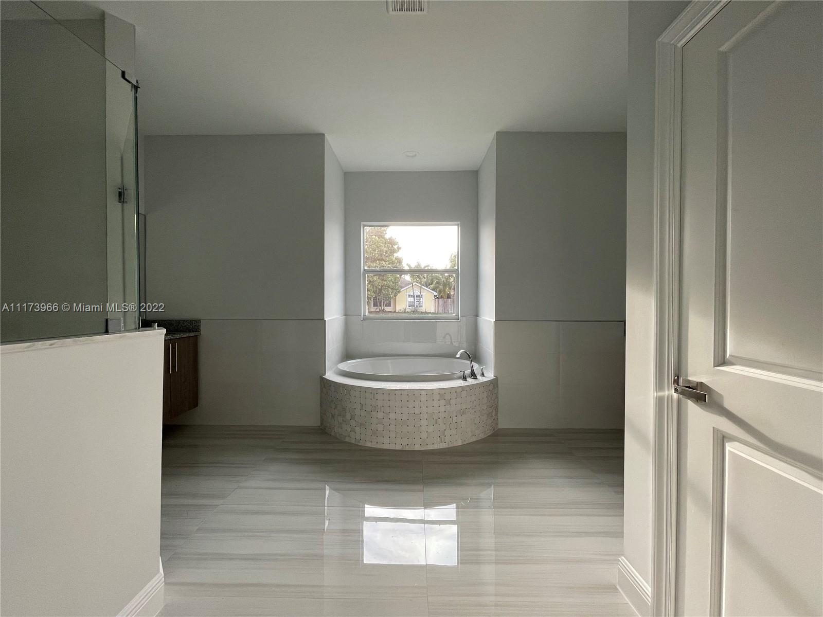 2072 Southwest Akorot Road Port St. Lucie, FL 34953 - Photo 6 of 14 a bathroom with a toilet and a bathtub