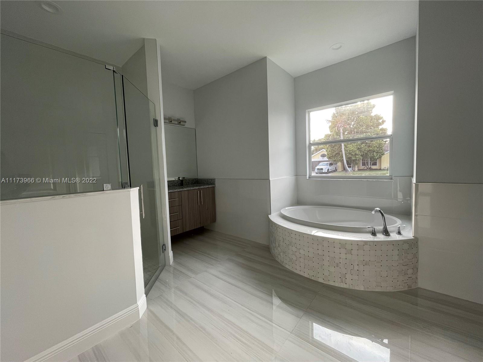 2072 Southwest Akorot Road Port St. Lucie, FL 34953 - Photo 8 of 14 a bathroom with a bathtub and a shower