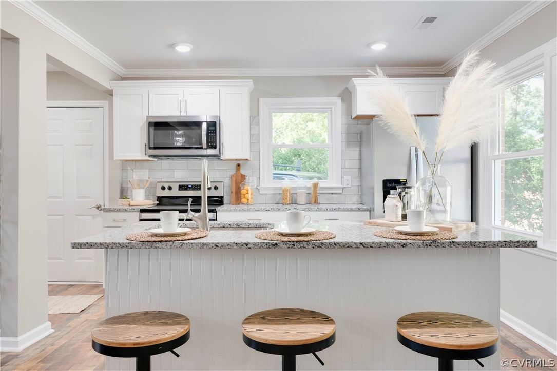10201 Ridgerun Road Chesterfield, VA 23832 - Photo 11 of 37 a kitchen with stainless steel appliances a sink a stove a microwave and cabinets