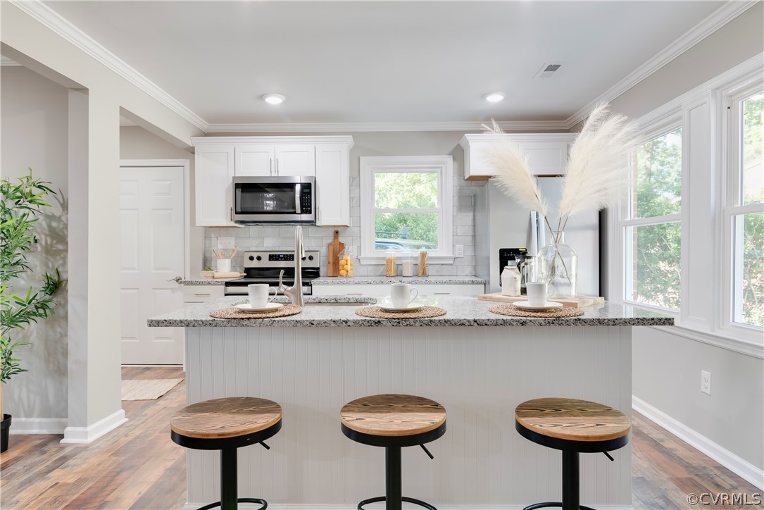 10201 Ridgerun Road Chesterfield, VA 23832 - Photo 10 of 37 a kitchen with stainless steel appliances a table and chairs in it