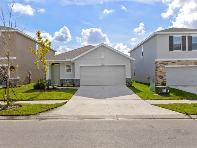 a front view of a house with a yard and garage
