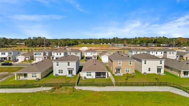 a view of houses with swimming pool and ocean view