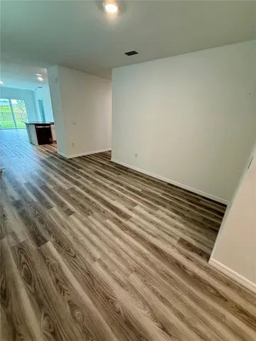 a view of an empty room and wooden floor