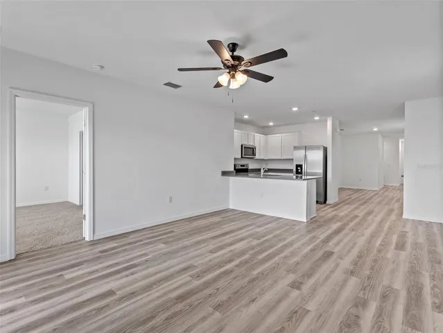 a view of a kitchen with a sink and wooden floor