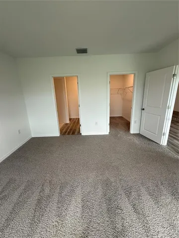 a view of an empty room and closet area