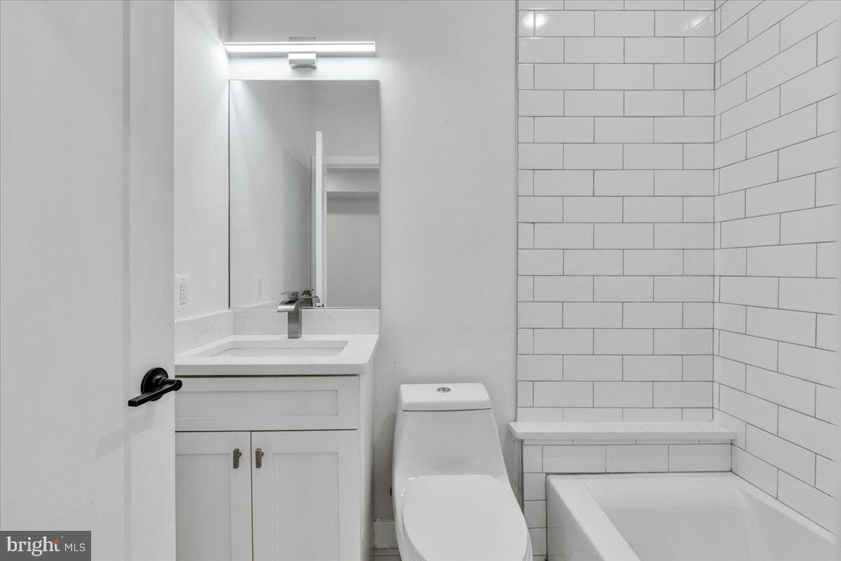 1416 22nd Street Southeast, Unit 9 Washington, DC 20020 - Photo 16 of 31 a bathroom with a sink a toilet and shower