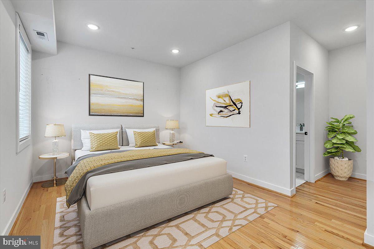 1416 22nd Street Southeast, Unit 9 Washington, DC 20020 - Photo 17 of 31 a bedroom with bed and a painting on the wall