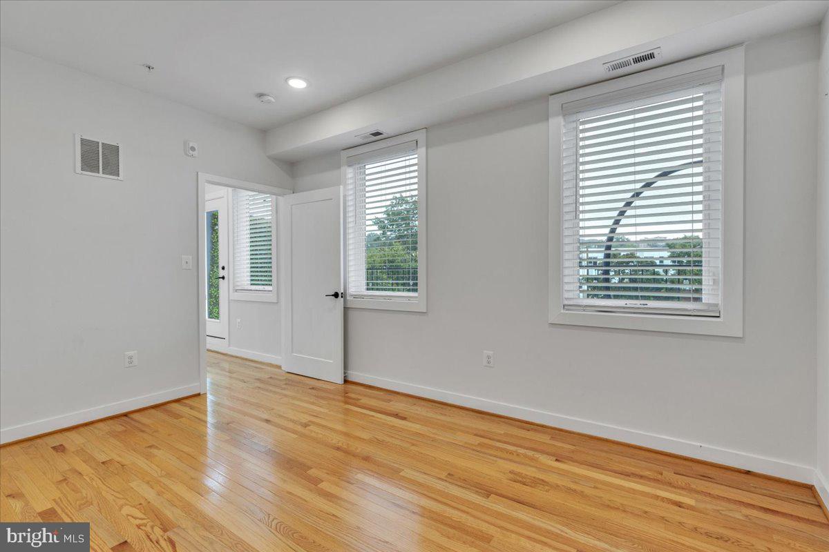1416 22nd Street Southeast, Unit 9 Washington, DC 20020 - Photo 20 of 31 a view of an empty room with wooden floor and a window