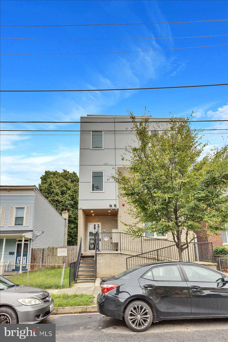 1416 22nd Street Southeast, Unit 9 Washington, DC 20020 - Photo 29 of 31 a front view of a house with parking area